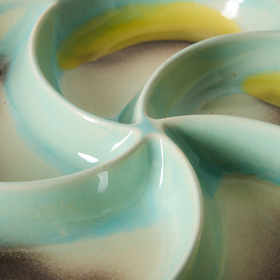 Close-up of a ceramic dish with blue and yellow design