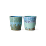 Two ceramic cups with decorative patterns on a white background