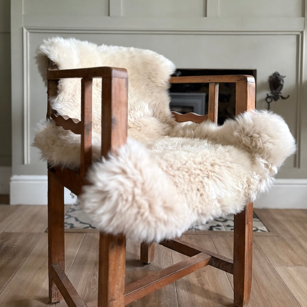 Wooden chair with white fur cover in a room setting