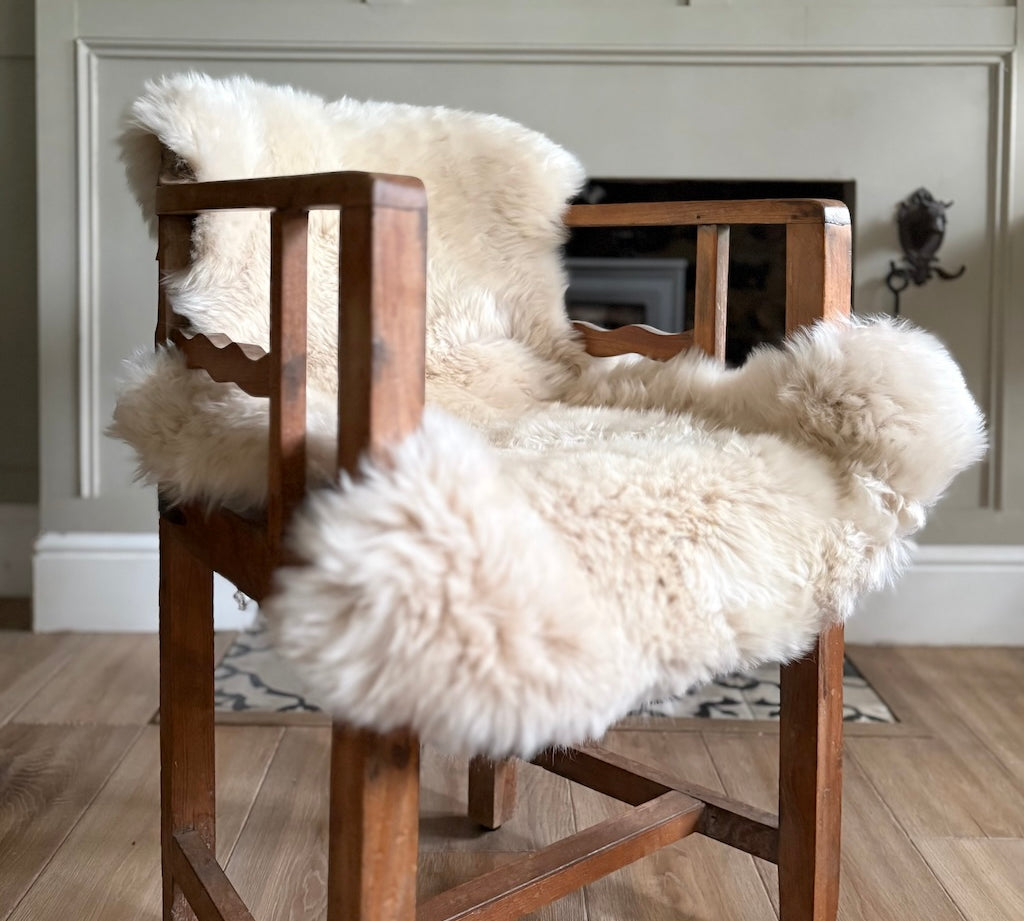 Wooden chair with white fur cover in a room setting