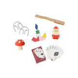 Collection of small toys and items including a mushroom, rake, cards, and ruler on a white background