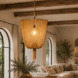 Cozy living room with wooden table, chairs, and a hanging lamp.