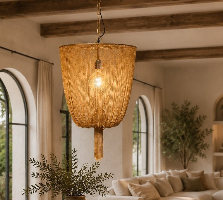 Cozy living room with wooden table, chairs, and a hanging lamp.