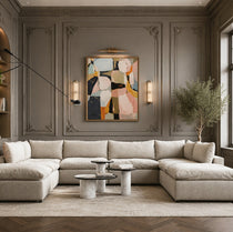 Modern living room with a sectional sofa, abstract painting, and decorative elements.