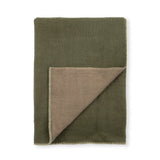 An olive green blanket with a folded corner revealing a taupe-brown reverse side, finished with a fringed edge, shown on a plain white background.