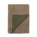 A folded wool blanket in a warm taupe-brown color, with one corner folded over to reveal an olive green reverse side and a visible whipstitch edge, set against a plain white background.