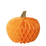 An orange honeycomb paper pumpkin decoration with a textured, pleated design and a small gold-colored stem, isolated on a white background.