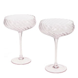 Two pink glasses goblets on a white background