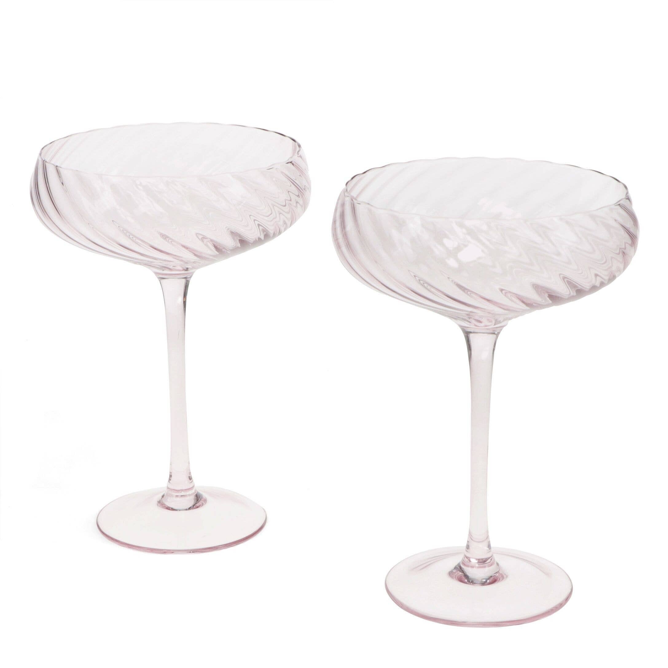 Two pink glasses goblets on a white background