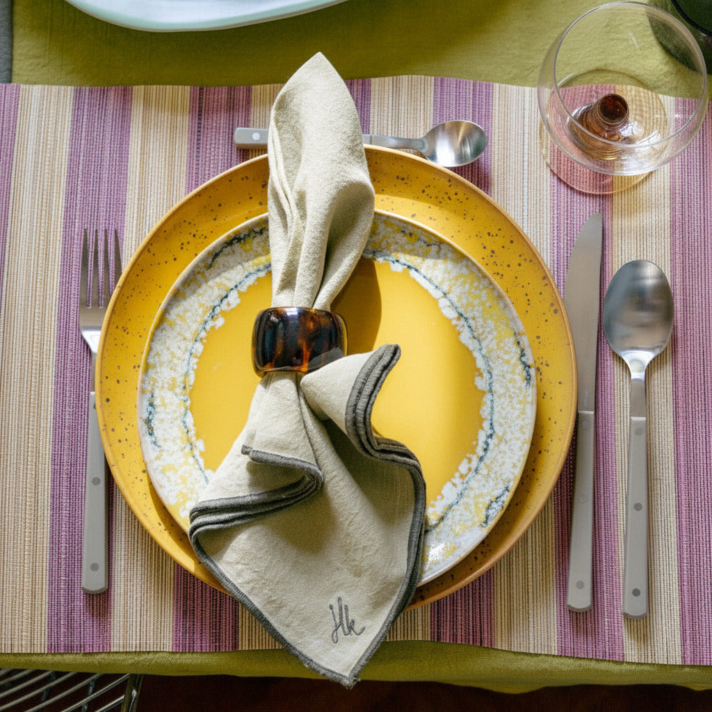 Dinner setting with a plate and striped placemat