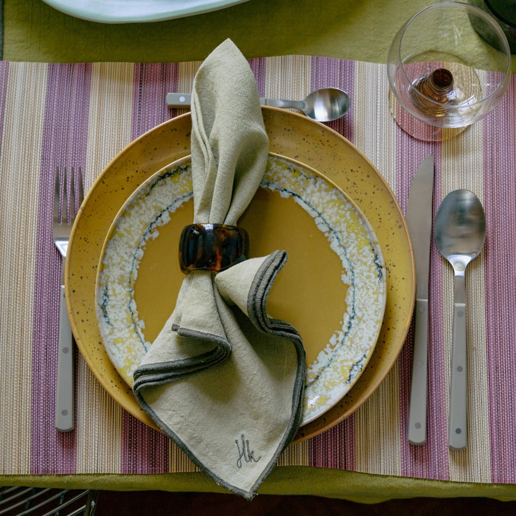 Dinner setting with a plate and striped placemat