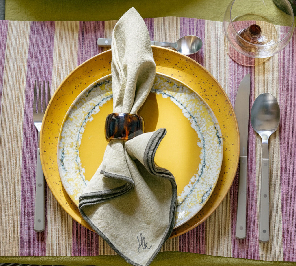 Dinner setting with a plate and striped placemat