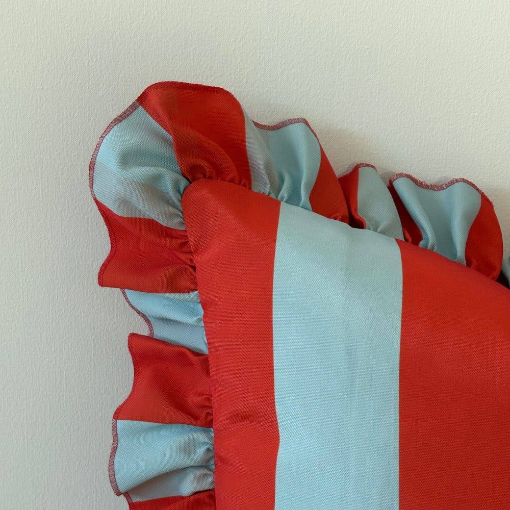 Red and light blue striped fabric on a white background
