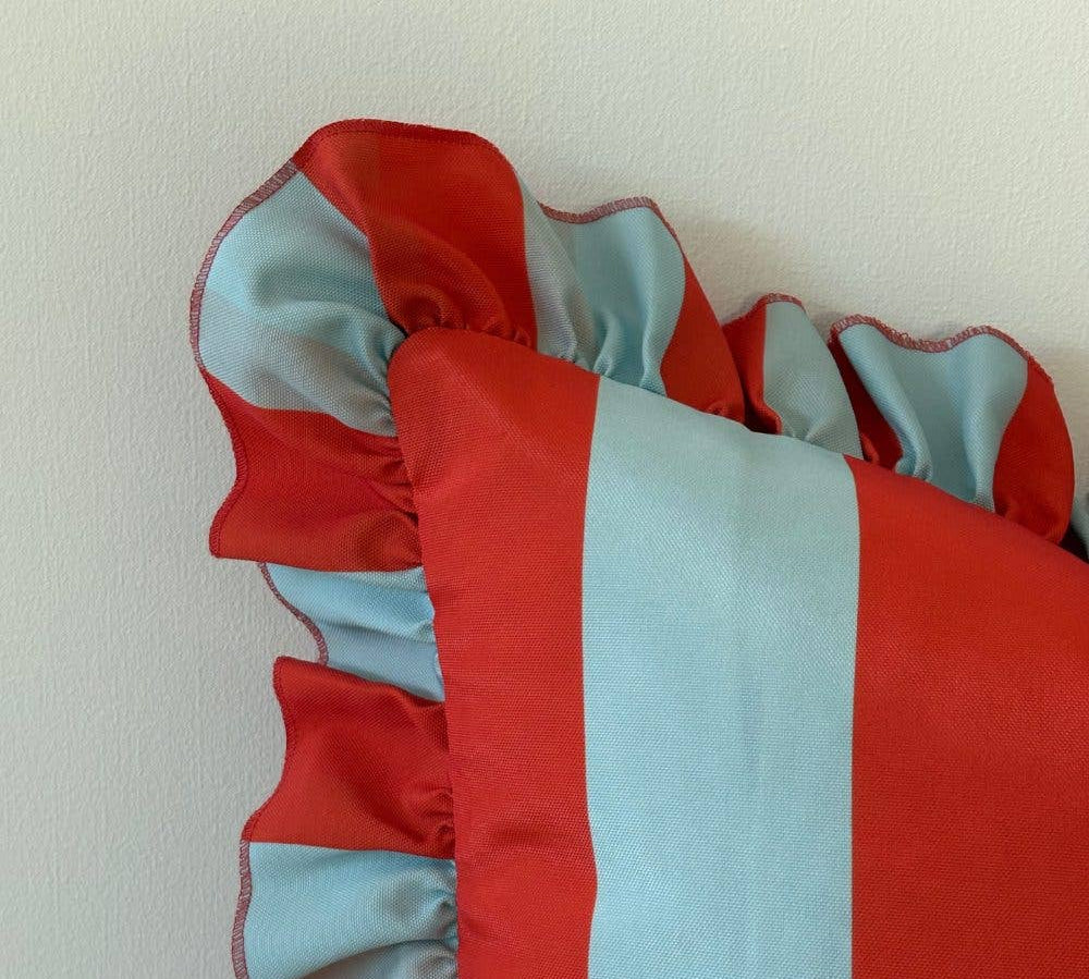 Red and light blue striped fabric on a white background