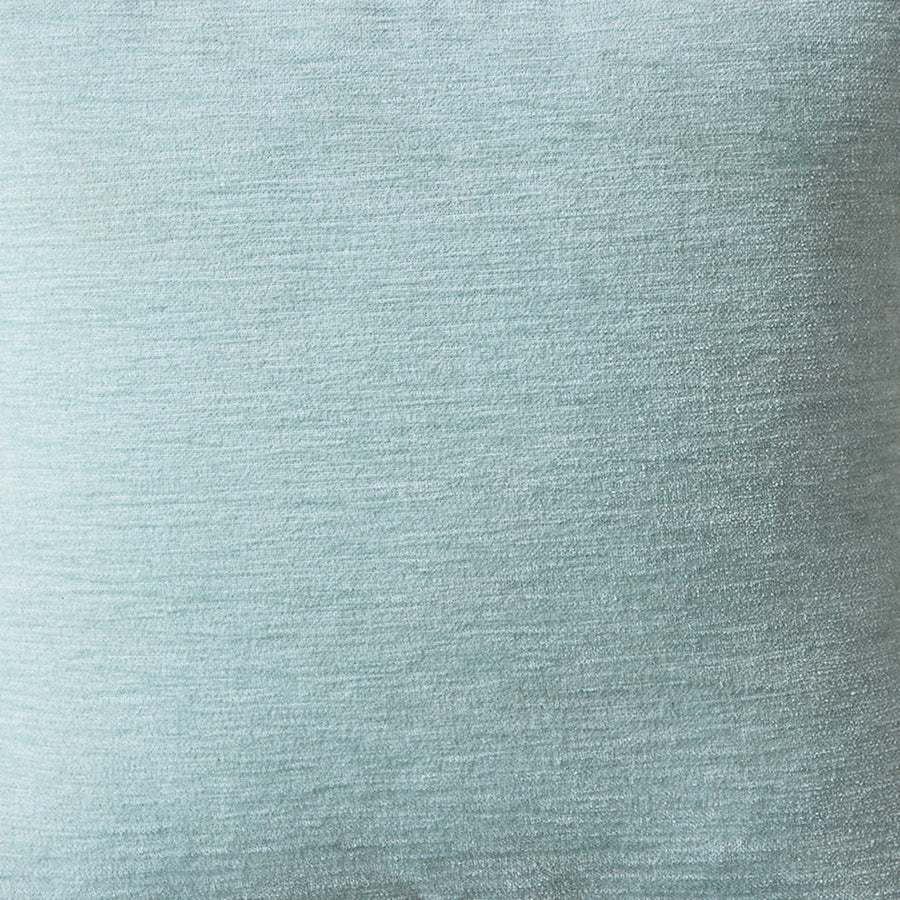 Close-up of a textured light blue fabric surface