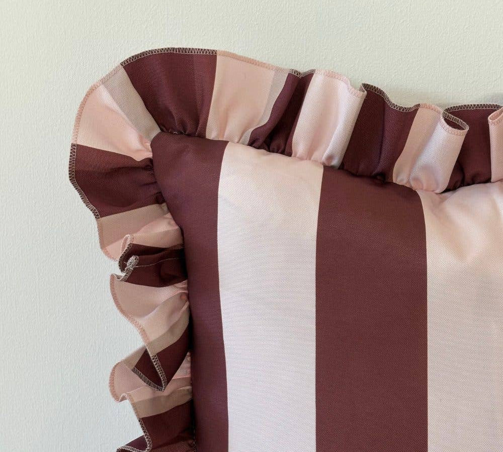 Striped fabric with red and pink colors on a light background