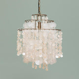 Chandelier with shell-like beads on a plain background