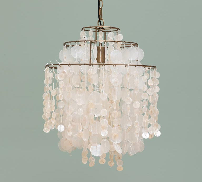 Chandelier with shell-like beads on a plain background
