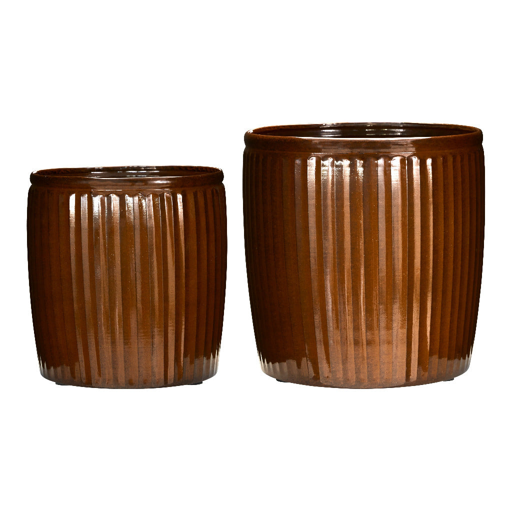 Two brown ribbed ceramic planters on a white background