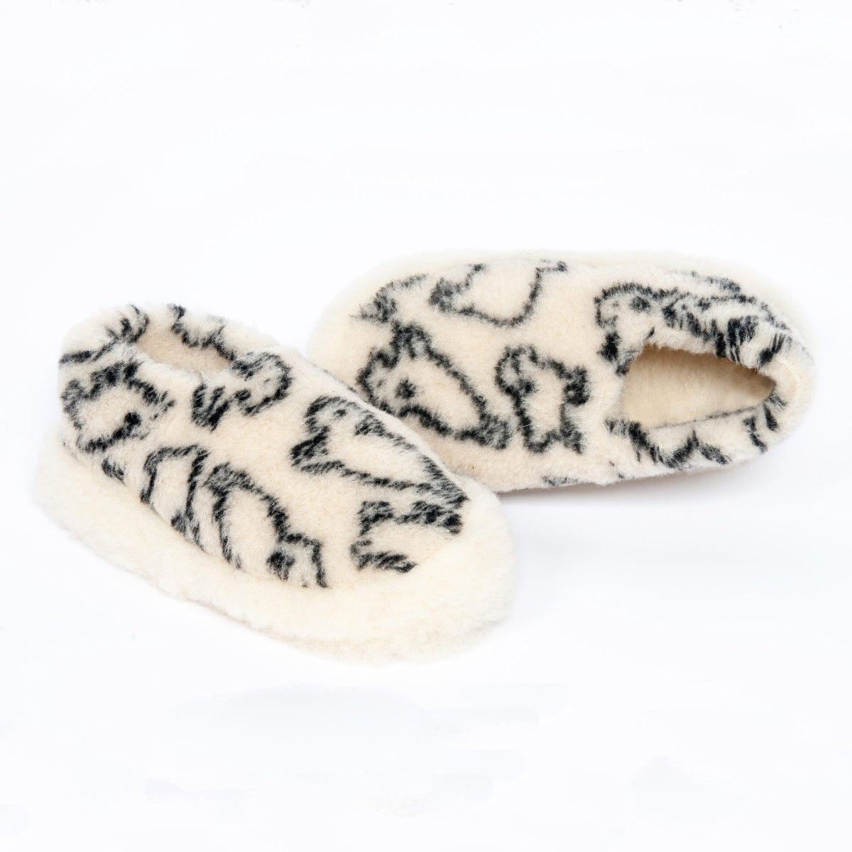 Pair of white wool fleece slippers with black pattern on a white background