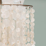 Chandelier with white circular beads on a light gray background