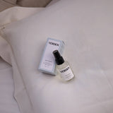 VERDEN bottle and box on a beige pillow