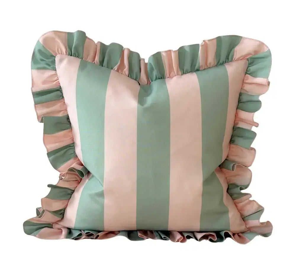 Striped cushion with ruffled edges in pink and green on a white background