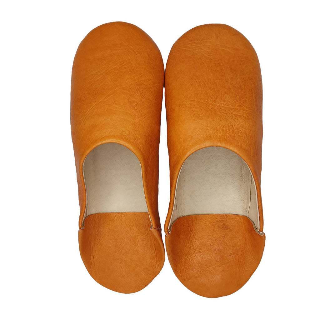 A pair of tan leather mule shoes shown from a top-down view on a solid white background.