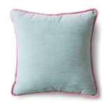 A square throw pillow in a light dusty blue fabric with a contrasting pink piped border, shown against a plain white background.