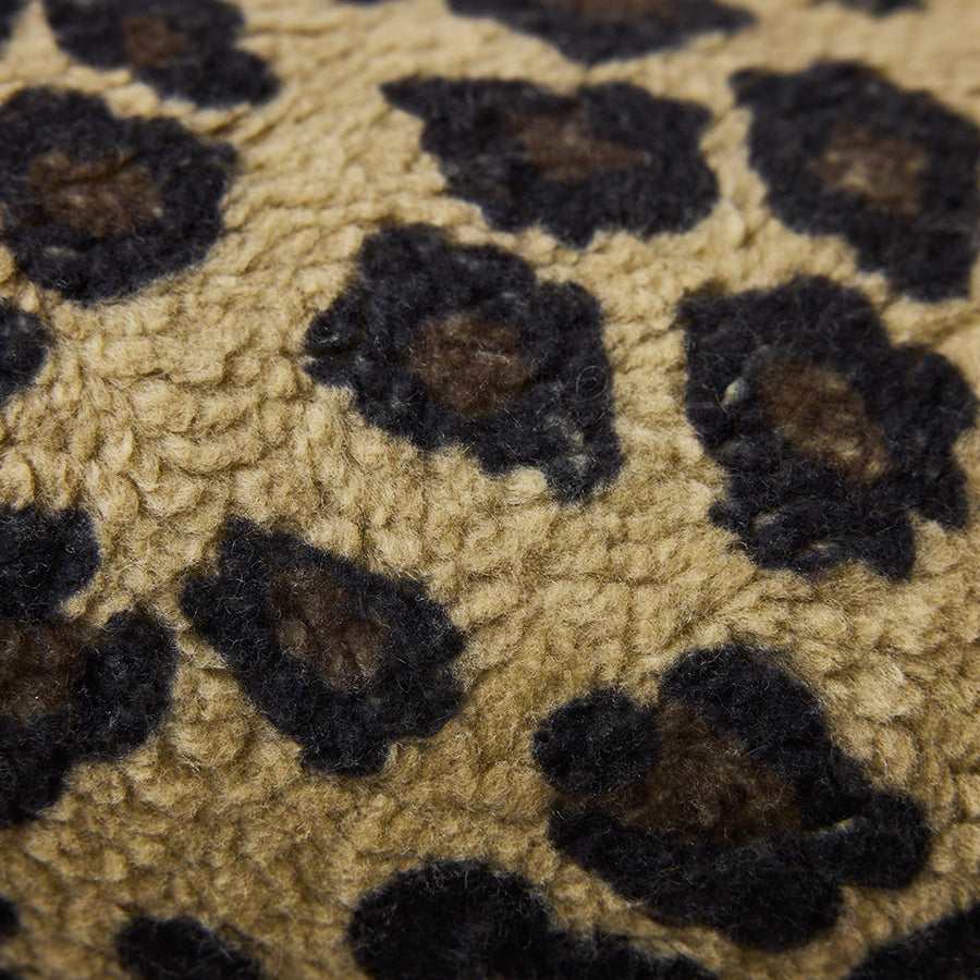 Close-up of a textured fabric with a leopard print pattern.