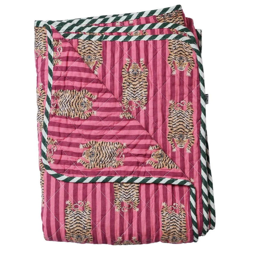 Pink quilt with tiger pattern and green and white striped border on a white background
