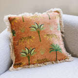 Decorative pillow with tiger and palm tree pattern on a couch