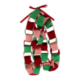 A festive paper chain garland made of alternating red, green, and pink paper loops tied together with a red ribbon bow at the top, shown on a plain white background.