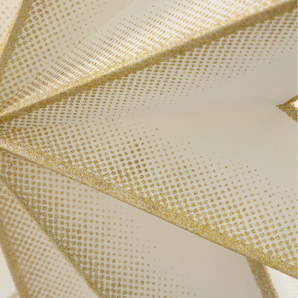 Close-up of star with gold glittery trim on a white background