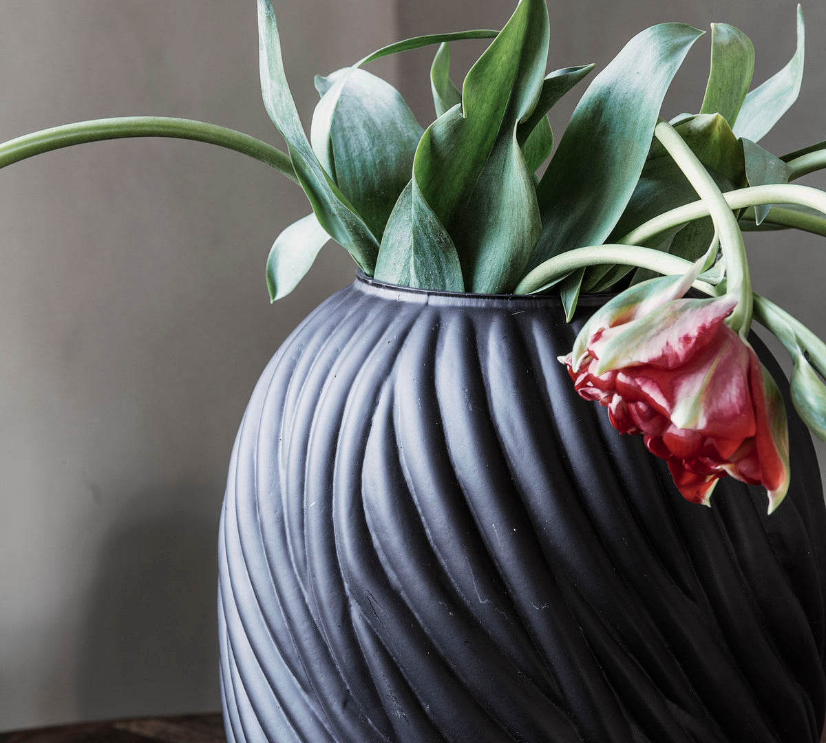 dark brown glass vase with a swirl texture 