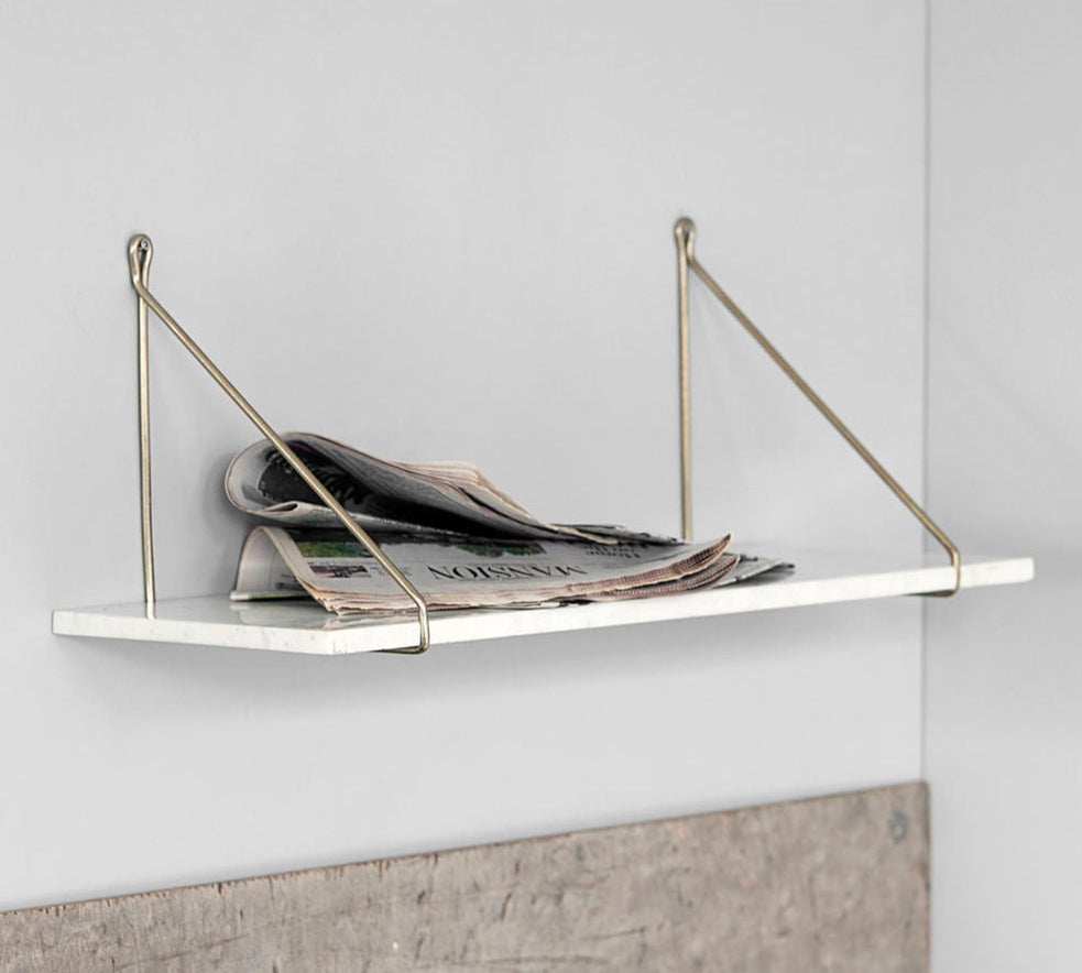 marble shelf with brass brackets 