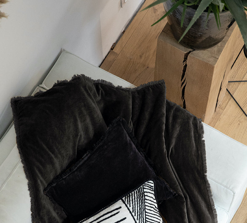 dark grey velvet throw with fringed edges