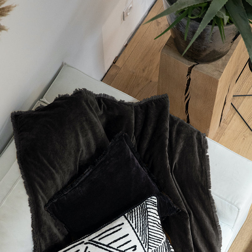 dark grey velvet throw with fringed edges