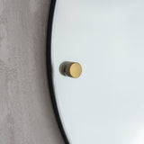 large round mirror with brass detail 