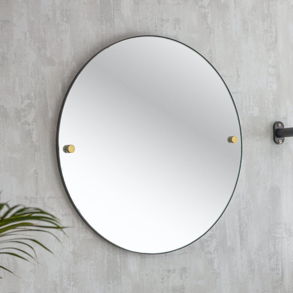 round mirror with brass bolts 
