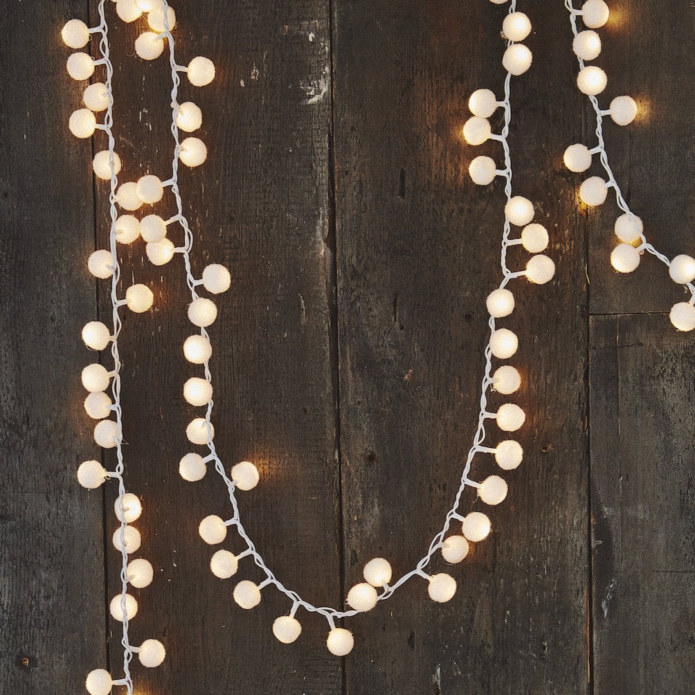white pompom lights on a garland