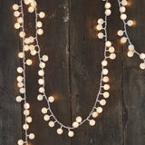 white pompom lights on a garland