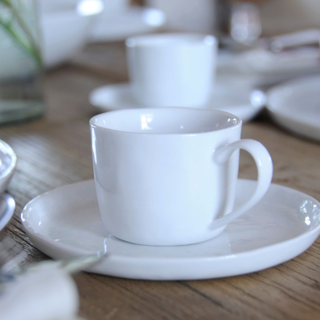 white porcelain cup and saucer