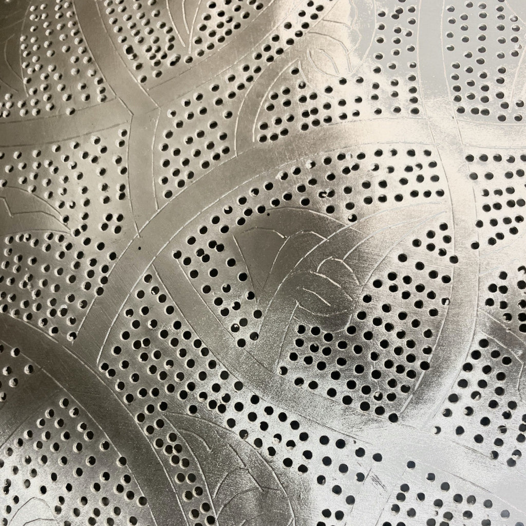 detail of hand punched Filigrain holes