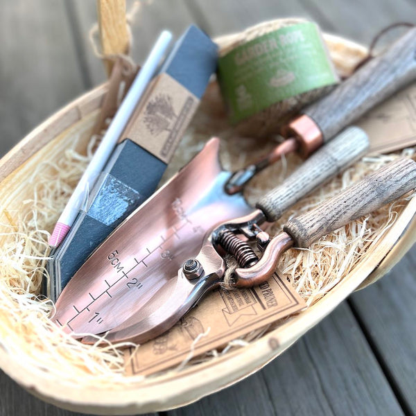 copper tools, twine, slate markers and wooden trug