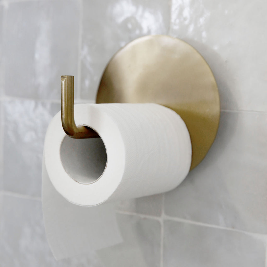 brass toilet roll holder in a simple modern style